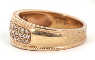 Lot 10 - A 9ct diamond ring, the 8mm wide band set with...