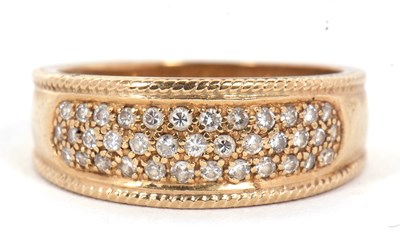 Lot 10 - A 9ct diamond ring, the 8mm wide band set with...