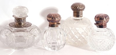 Lot 16 - Group of four cut glass table scent bottles to...