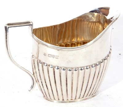 Lot 30 - Edwardian silver cream jug of oval form, half...