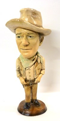 Lot 329 - A ceramic sculpture of John Wayne on circular...