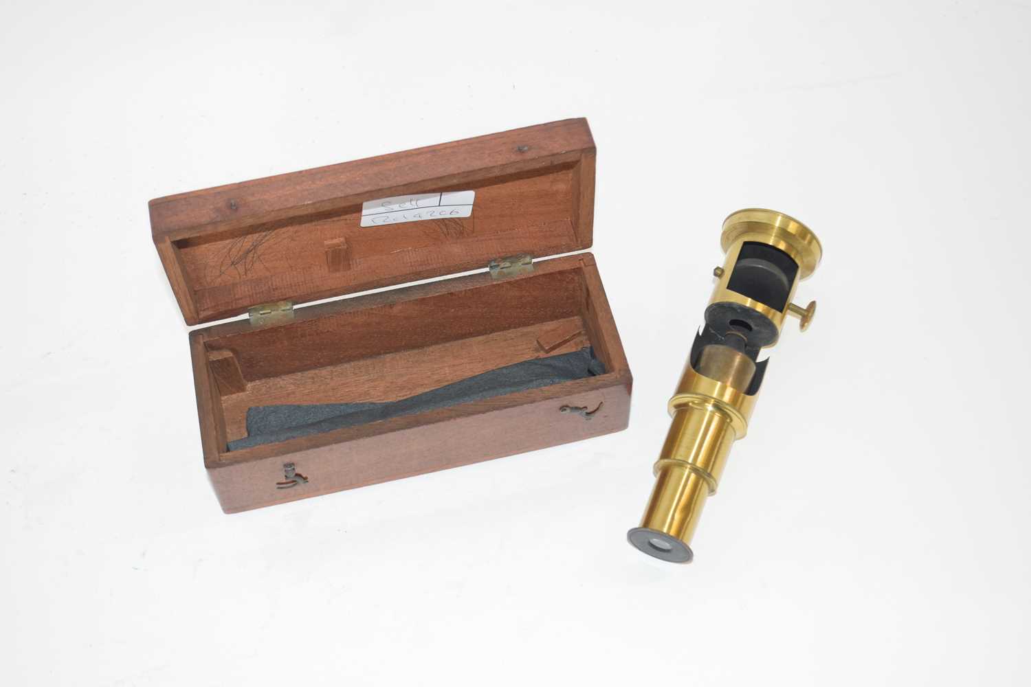 Lot 406 - A small microscope in wooden case