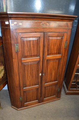 Lot 560 - A large Georgian mahogany corner cabinet with...