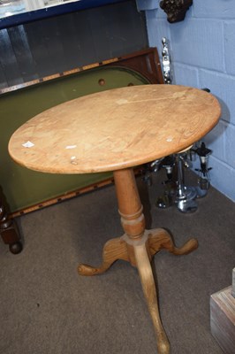 Lot 574 - A pine tripod based table with circular top...