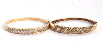 Lot 184 - A 9ct and diamond hinged bangle, the 8mm wide...
