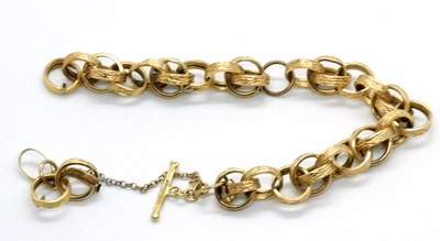 Lot 148 - An 18ct fancy link bracelet, the textured...