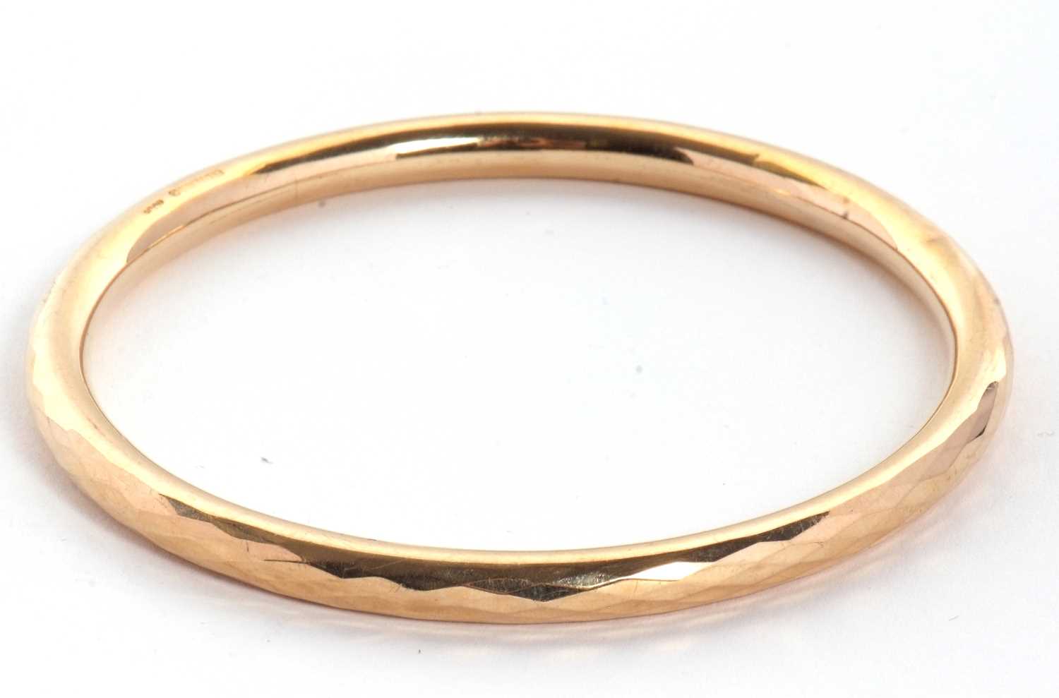 Lot 84 - A 9ct upper arm bangle, the hollow bangle...