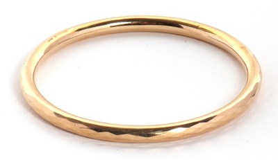 Lot 84 - A 9ct upper arm bangle, the hollow bangle...