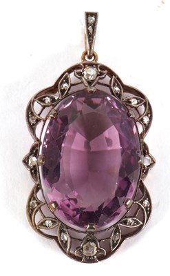 Lot 107 - An amethyst and diamond pendant, the oval claw...