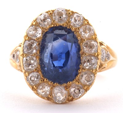 Lot 307 - A sapphire and diamond ring, the oval mixed...