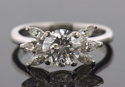 Lot 324 - A diamond cluster ring, the central round...