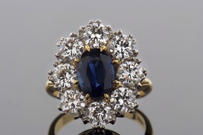 Lot 317 - A sapphire and diamond cluster ring, the...