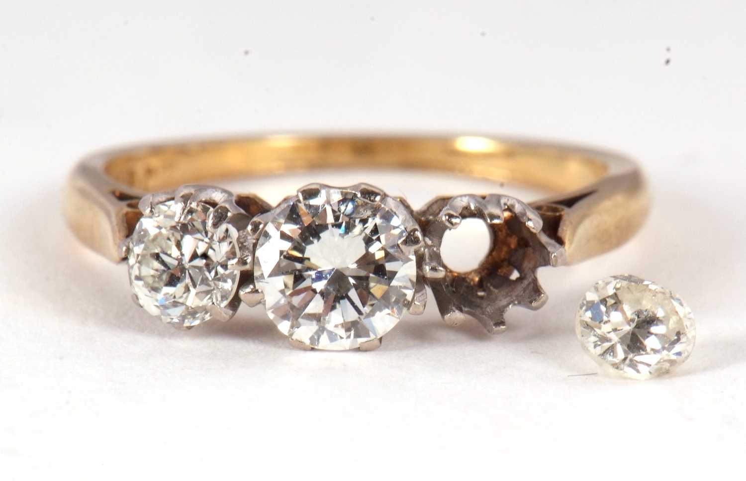 Lot 79 - A three stone diamond ring, the three...