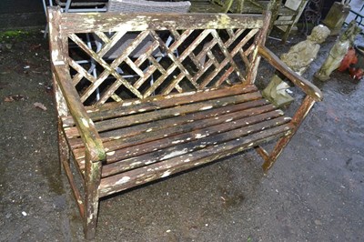 Lot 365 - Weathered wooden garden bench with lattice...