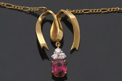 Lot 322 - A ruby and diamond pendant necklace, the oval...