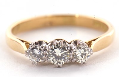 Lot 44 - A three stone diamond ring, the three round...