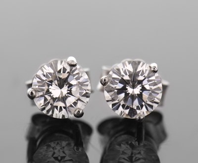 Lot 327 - A pair of diamond earstuds, the round...