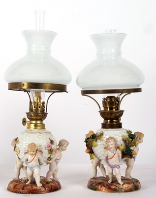 Lot 13 - A pair of continental porcelain lamps with...