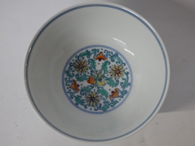 Lot 257 - A Chinese Wucai bowl with flowerheads amongst...
