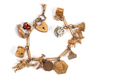 Lot 207 - A fancy link charm bracelet, with heart shape...
