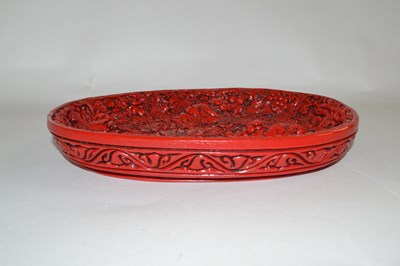 Lot 361 - A Chinese red lacquer dish with raised relief...