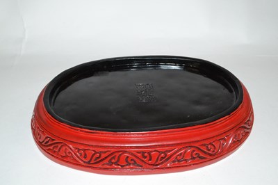 Lot 361 - A Chinese red lacquer dish with raised relief...