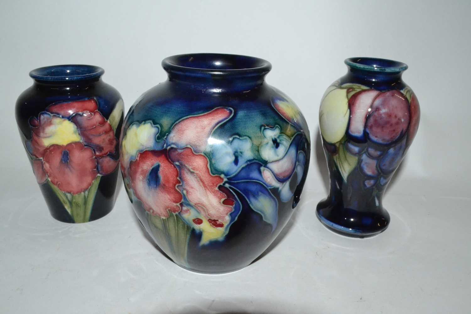 Lot 396 - Group of three small Moorcroft vases, the blue...