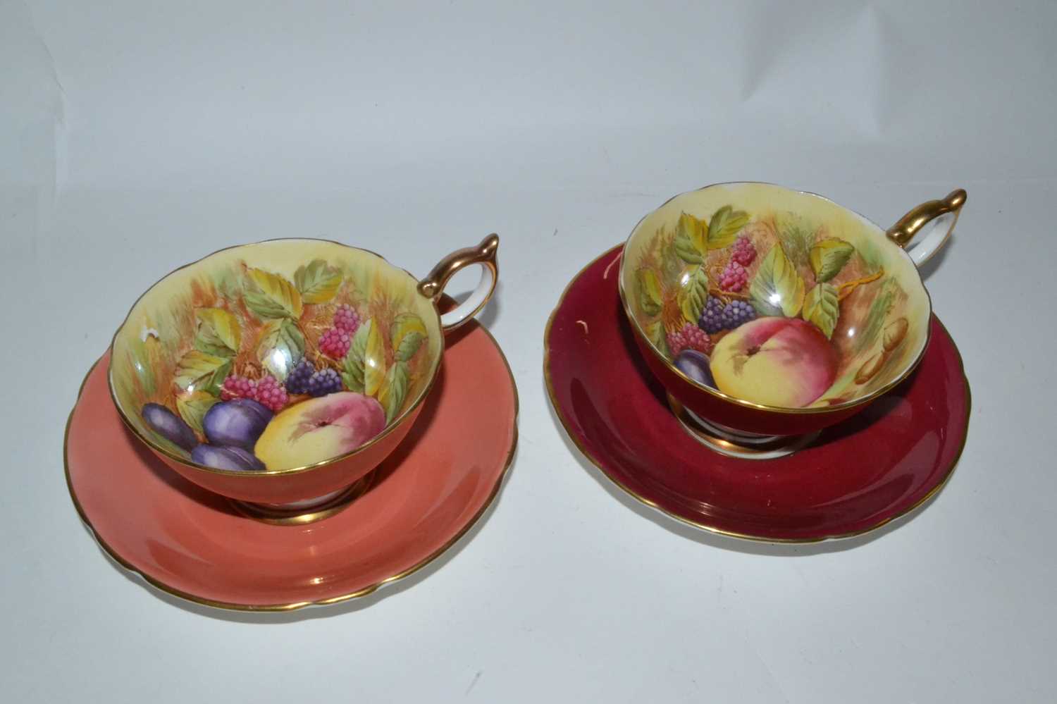 Lot 403 - A pair of Aynsley cups and saucers decorated...