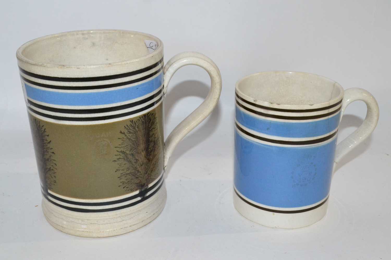 Lot 437 - Two Mocha ware mugs, one with engraved quart mark