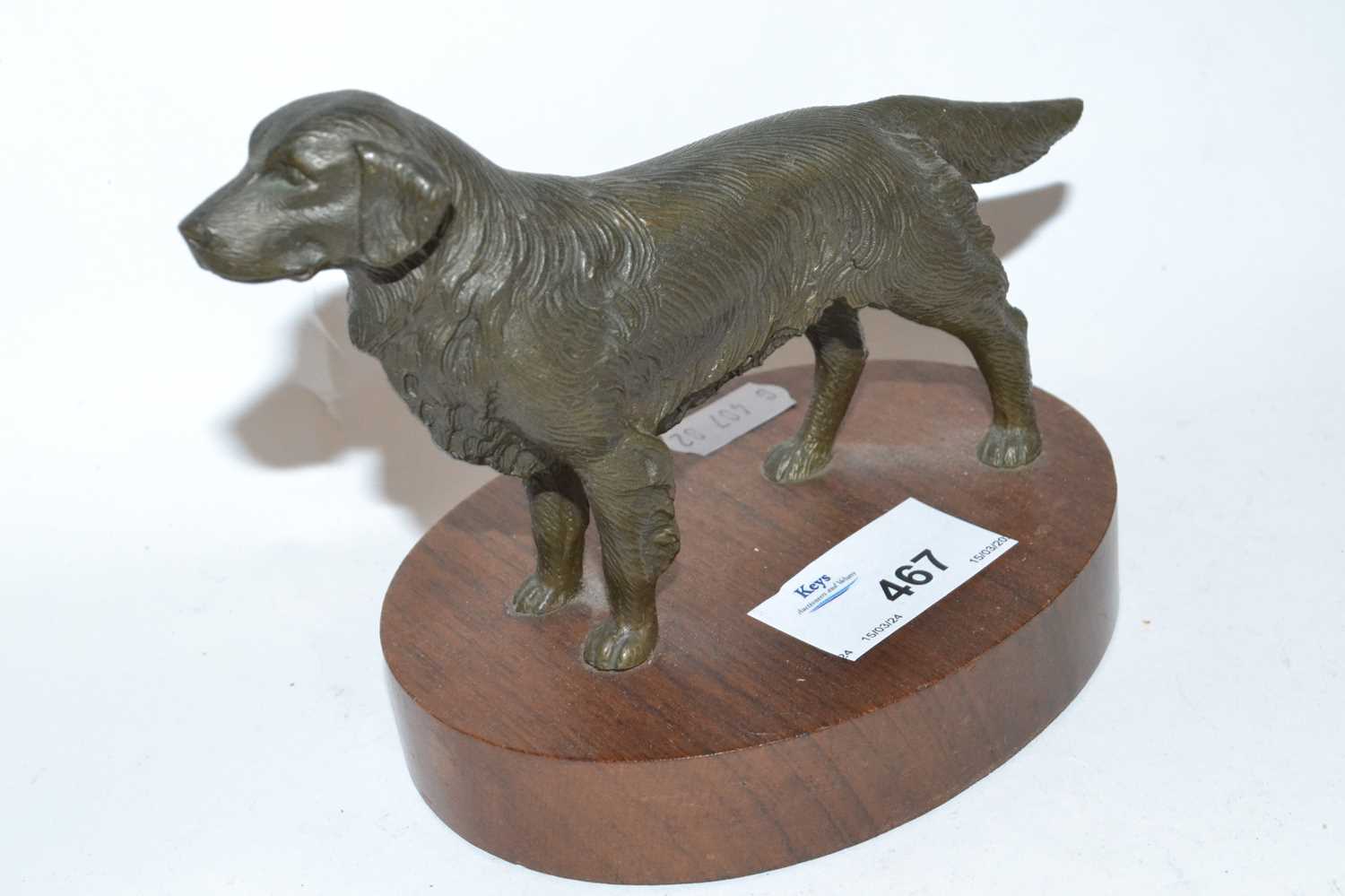 Lot 467 - A bronzed model of a retriever on oval wooden...