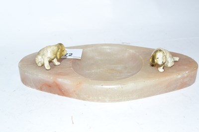 Lot 472 - An onyx ashtray mounted with two painted dogs