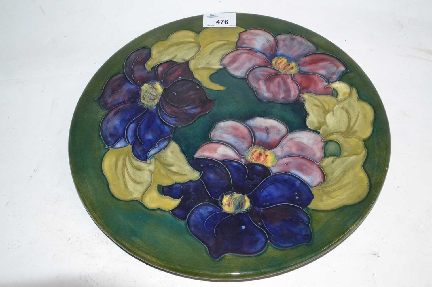Lot 476 - A Moorcroft charger, the green ground...