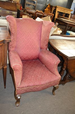 Lot 598 - A Georgian style wing back armchair, for...