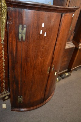 Lot 654 - A George III mahogany bow front two door wall...