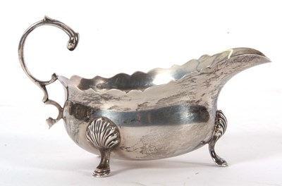 Lot 4 - A George VI silver sauce boat of typical form...