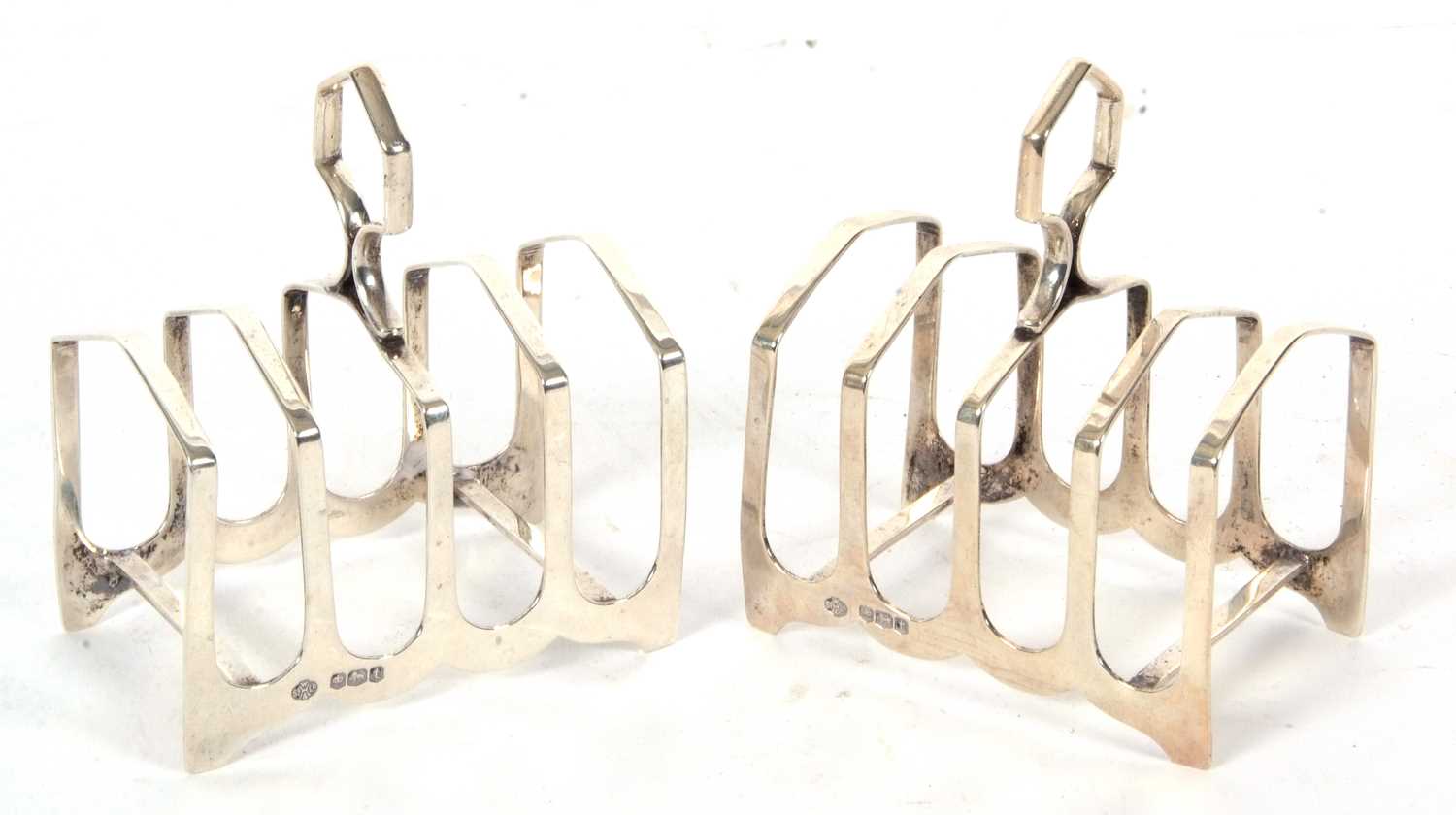 Lot 28 - Pair of Art Deco silver toast racks of angular...