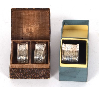 Lot 85 - A boxed pair of silver serviette rings, chased...