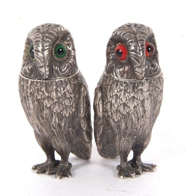 Lot 129 - Pair of silver plate owl peppers with green...