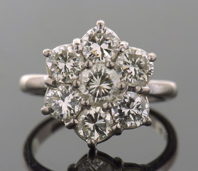 Lot 373 - A diamond flowerhead cluster ring, the central...