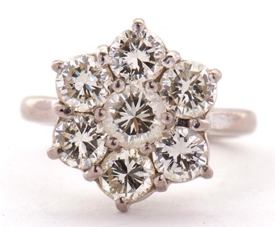 Lot 373 - A diamond flowerhead cluster ring, the central...