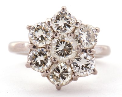 Lot 373 - A diamond flowerhead cluster ring, the central...