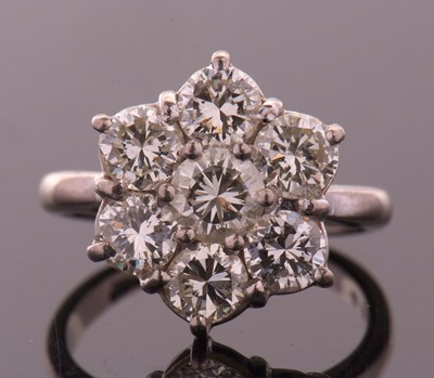 Lot 373 - A diamond flowerhead cluster ring, the central...