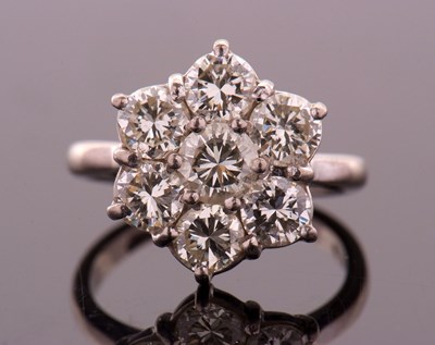 Lot 373 - A diamond flowerhead cluster ring, the central...