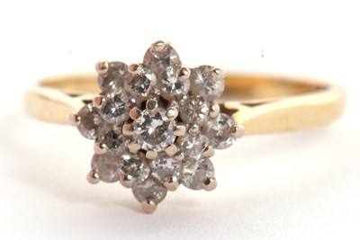 Lot 3 - An 18ct diamond cluster ring, the central...