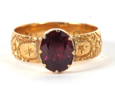 Lot 39 - A garnet ring, the oval collet and claw...