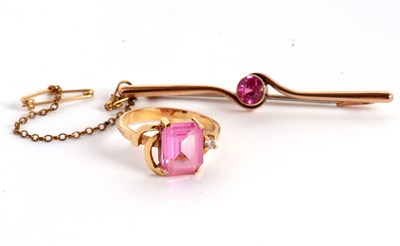 Lot 125 - An 18k synthetic pink sapphire and white stone...