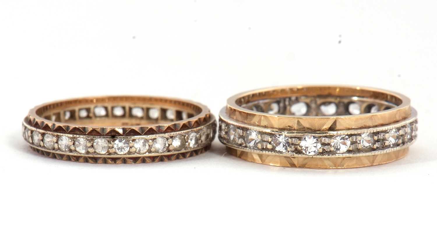 Lot 67 - Two eternity rings, one with a central channel...
