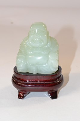 Lot 331 - A jadite figure of a Buddha on wooden stand