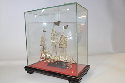 Lot 282 - A white metal model of a Chinese junk, in...