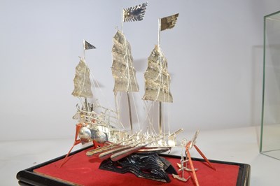 Lot 282 - A white metal model of a Chinese junk, in...